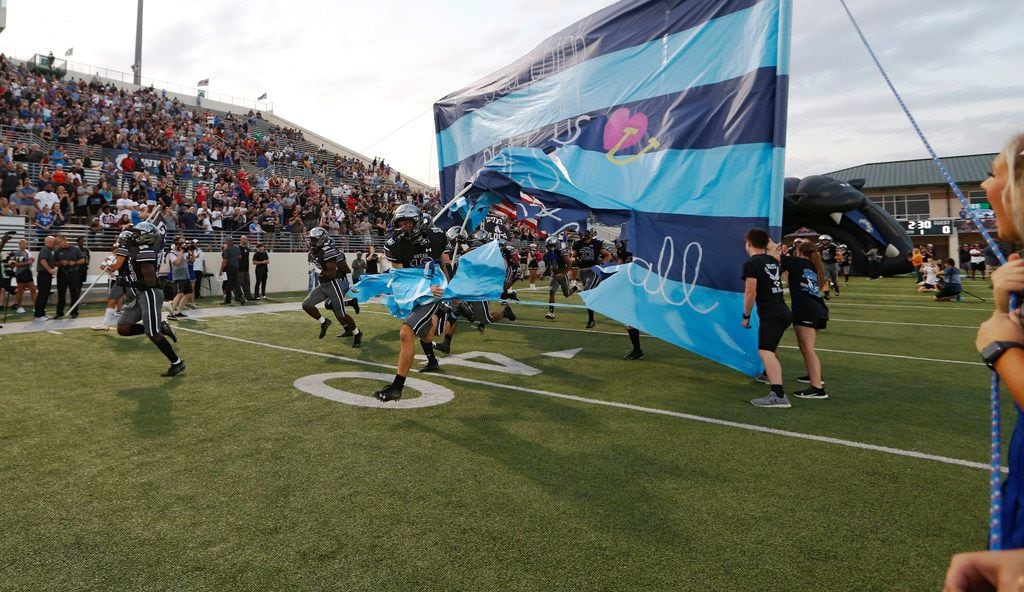 Denton Guyer takes the football field during introductions before a football game against...
