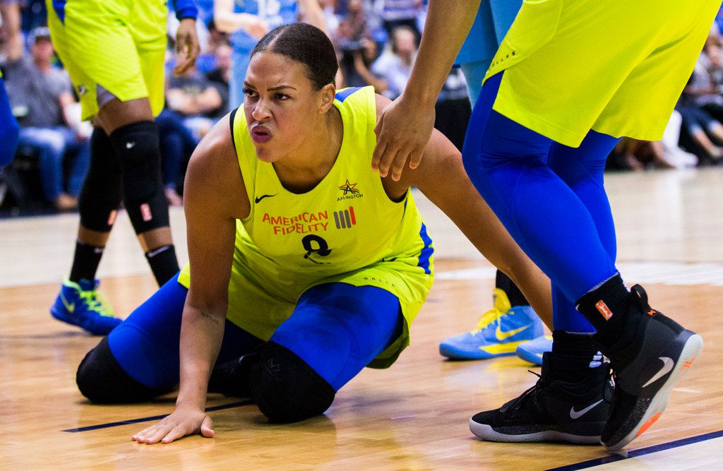 Dallas Wings center Liz Cambage (8) slaps the floor after a foul during the third quarter of...