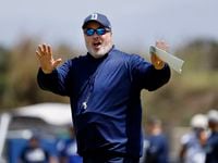 Dallas Cowboys head coach Mike McCarthy yells to the media to clarify he’s calling fake...