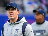 Dallas Cowboys offensive coordinator Kellen Moore takes the field before the first half of an NFL football game against the New York Giants on Sunday, Dec. 19, 2021, in East Rutherford, N.J.