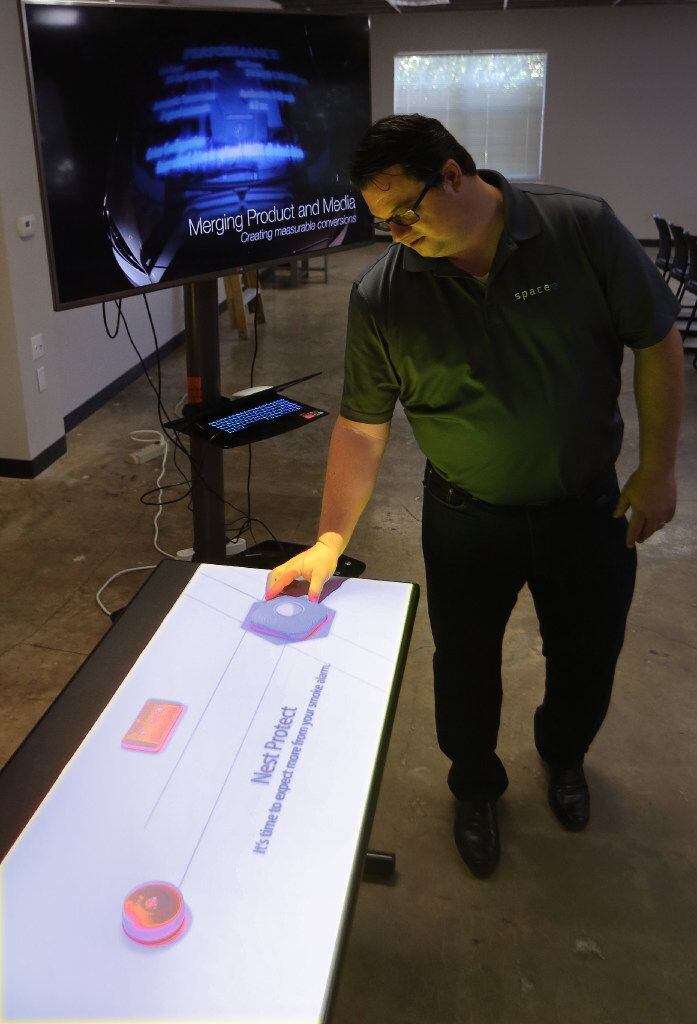 Spacee's technology can turn the surface of a car, table or display case into an interactive touch screen. In this display, a projector can make plastic shapes look like a smart thermostat or an iPhone. The display mimics the look and function of a product, without the need for security devices or risk of theft. (Louis DeLuca/The Dallas Morning News)