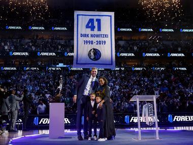 Former Dallas Mavericks All-Star Dirk Nowitzki, his wife Jessica Olsson and their kids pose for a photo as they watched his retired No. 41 being lifted from the floor at the American Airlines Center in Dallas, January 5, 2022.
