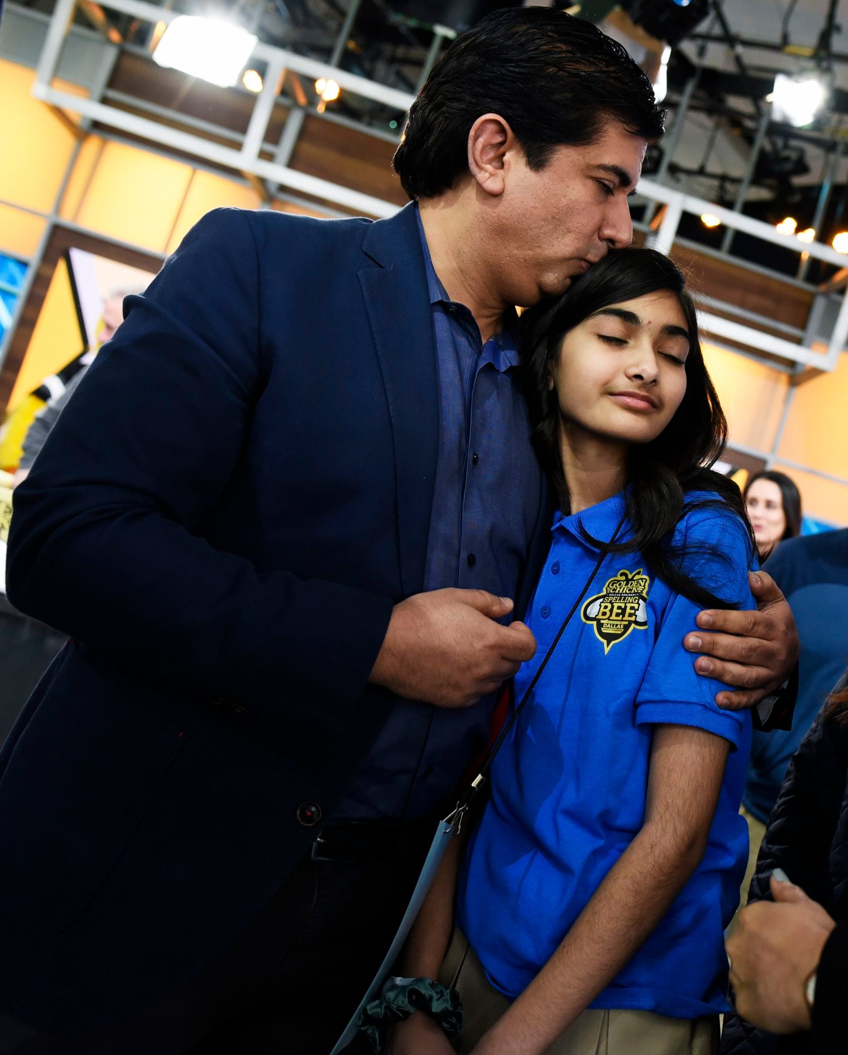 Shaad Bidiwala gives his daughter, 12-year-old Saida, a kiss after she was eliminated with only a few competitors remaining at the Golden Chick Dallas Regional Spelling Bee on Saturday.