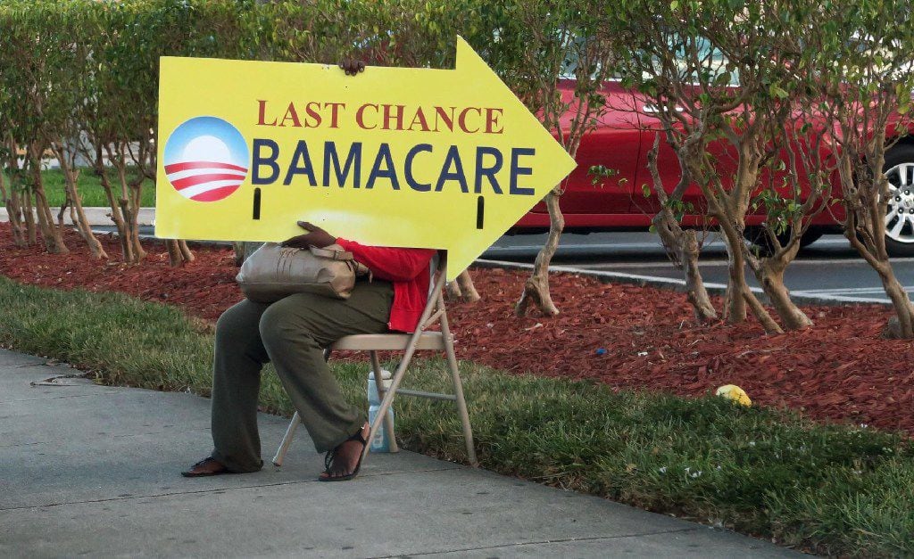 (FILES) This file photo taken on November 27, 2016 shows a woman holding an Obama Care sign...