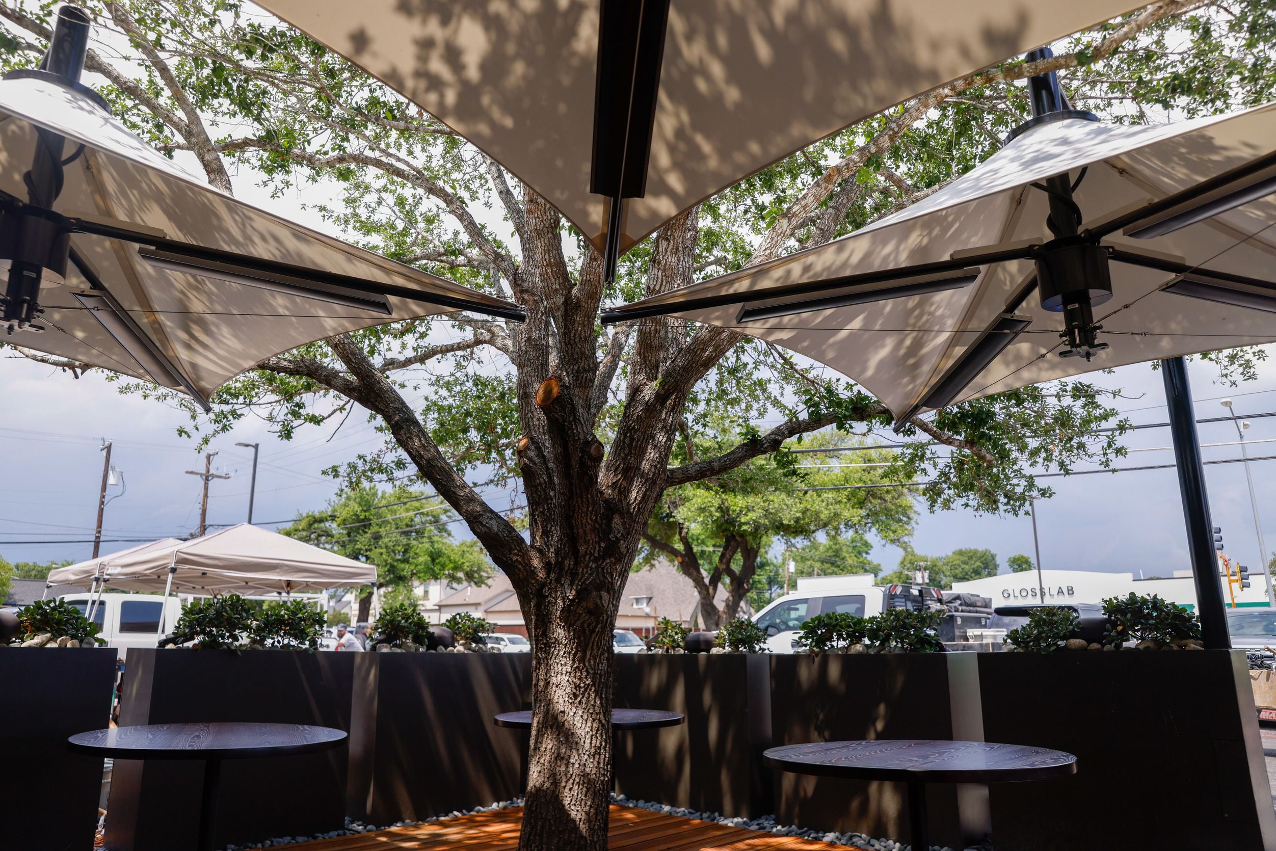A tree planted at Bobbie's Airway Grill grows in the center of the patio of the new...