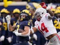 Michigan running back Blake Corum (2) is chased by Ohio State safety Ronnie Hickman during...