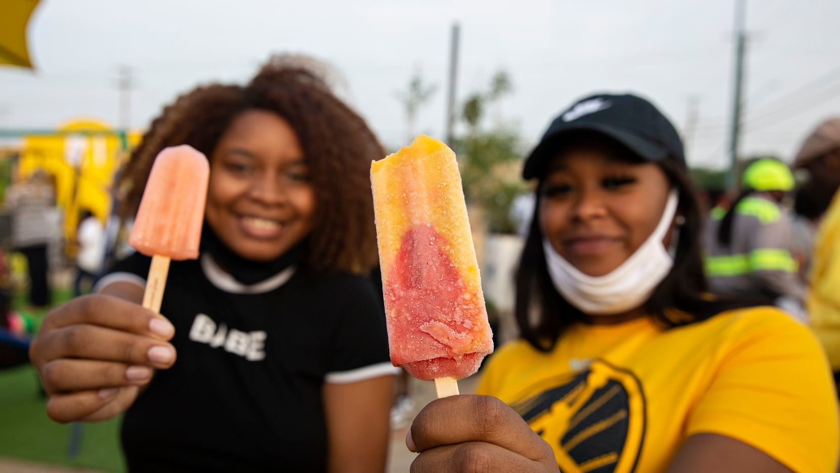 DayJus Hill and Tatiana Laury hold up their popsicles they got from the Frios Gourmet Pops...