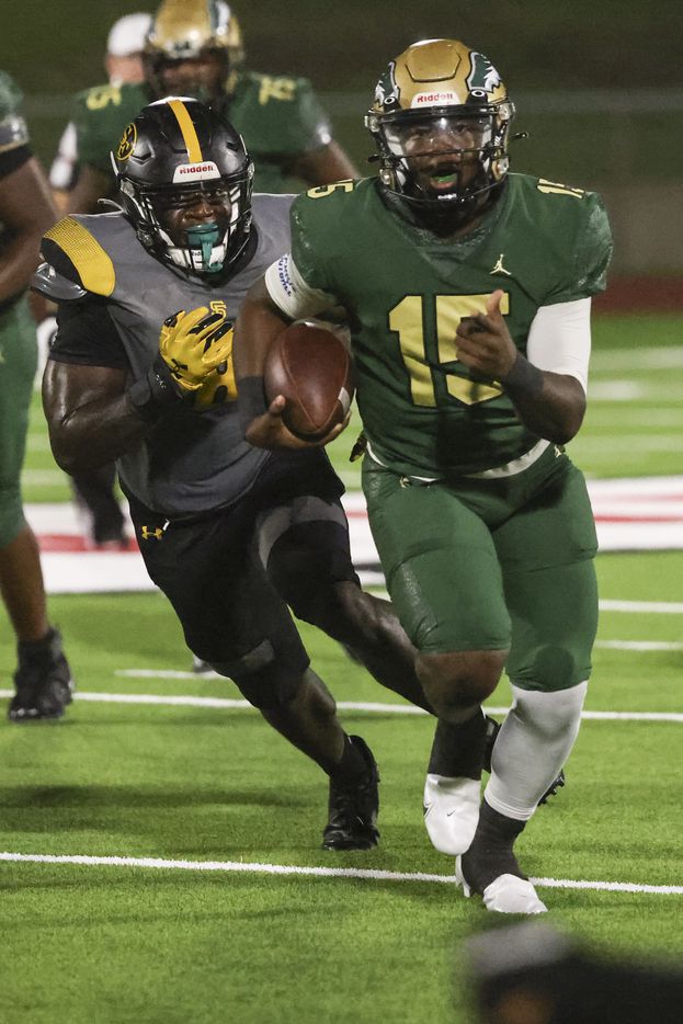 DeSoto High School Darius Bailey (15) runs the ball up the field while trailed by St....