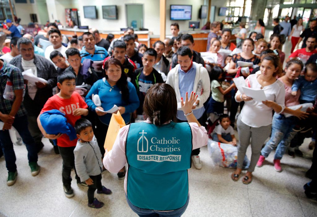 A staffer from the Catholic Charities of the Rio Grande Valley gives instructions to Central...