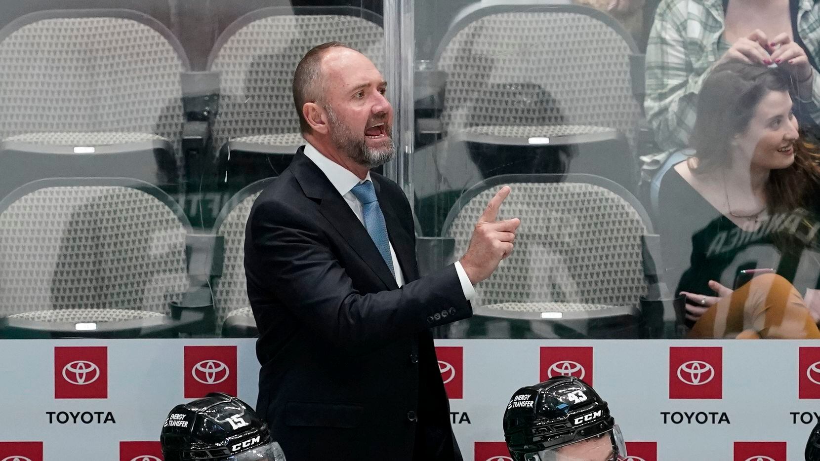 Dallas Stars head coach Peter DeBoer, top, instructs his team on the ice in the third period...