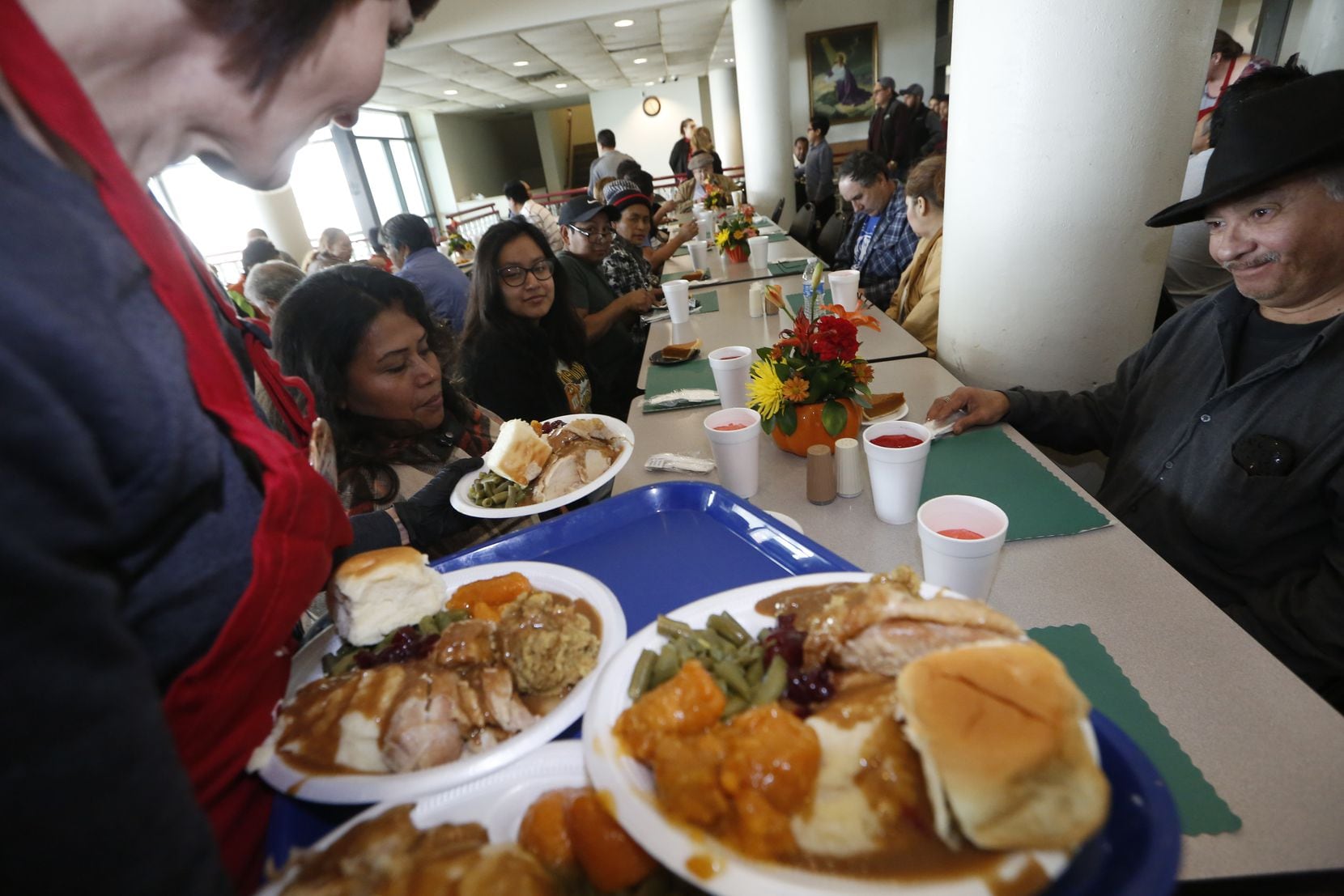 From left: Jacqueline Gonzalez, Sara Carlos and Vincent Camacho are served their...