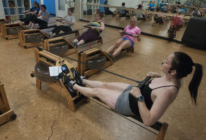 Karen Soltero, co-owner of Crowbar Cardio, teaches a rowing class.  After she started the...