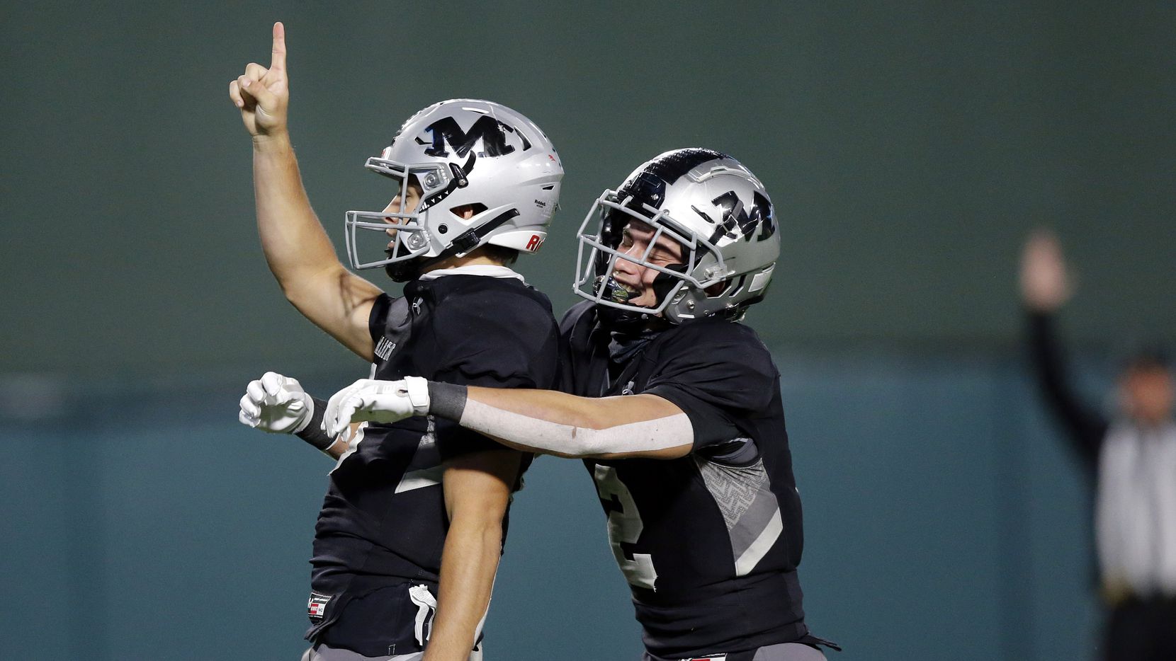 Arlington Martin quarterback Zach Mundell (left) is congratulated by teammate Cydd Ford (2) after scoring the winning touchdown in overtime against Arlington Lamar at Globe Life Park in Arlington, Friday, October 30, 2020. Martin defeated Lamar in overtime, 38-31.