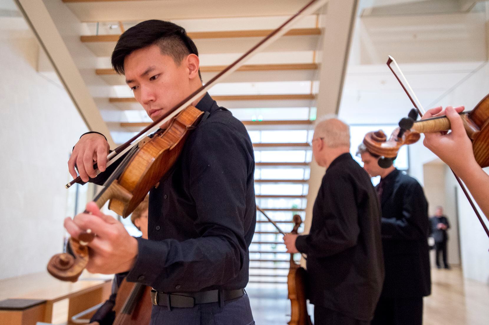 Daniel Chong, violinist in the Parker Quartet, plays his instrument during a break in the ...