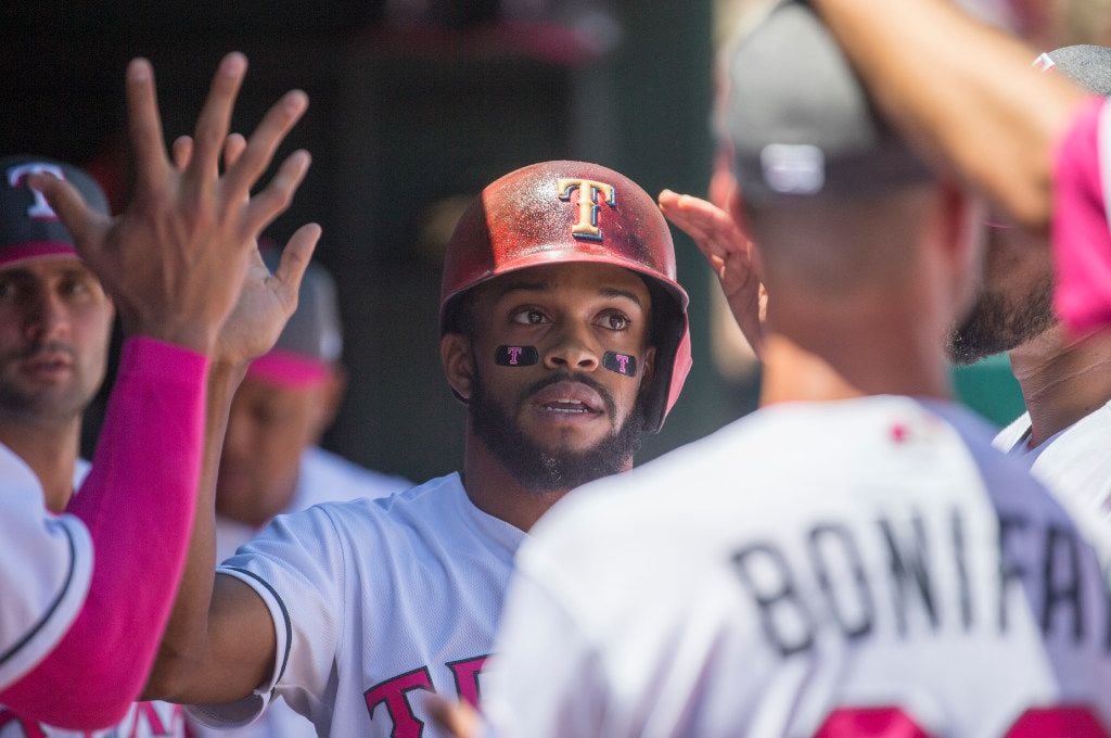 Texas Rangers left fielder Delino DeShields (3) celebrates with team mates after he crossed...