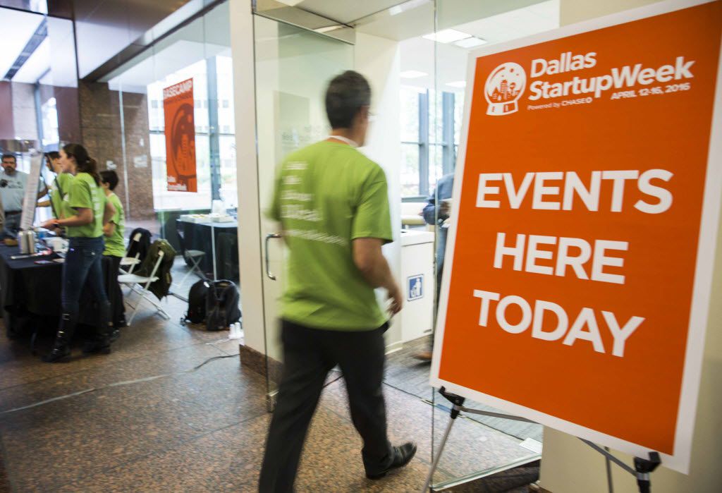A volunteer enters a lounge area during Dallas Startup Week activities on Tuesday, April 12,...