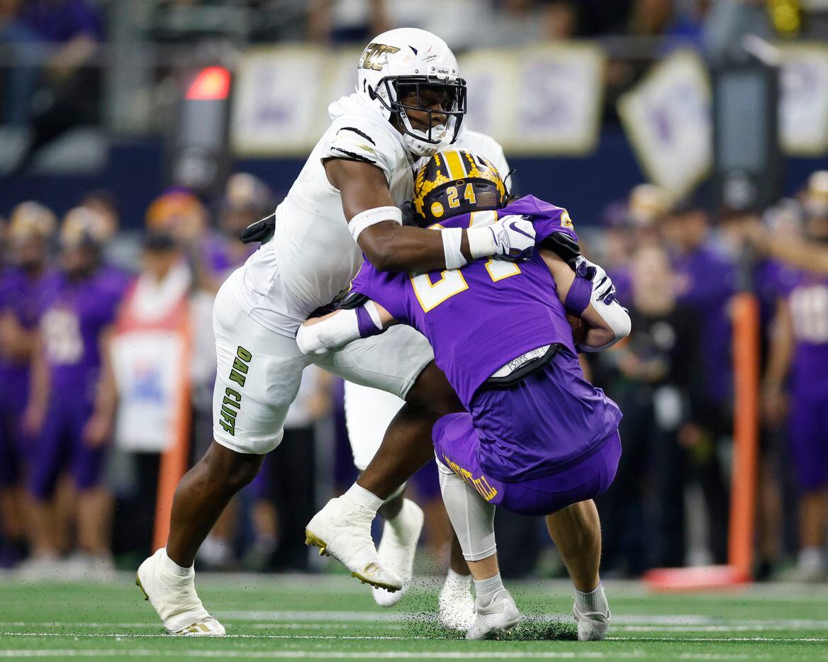 South Oak Cliff defensive back Kyron Chambers (2) tackles Liberty Hill defensive back Carter Hudson (24) during the first quarter of their Class 5A Division II state championship game at AT&T Stadium in Arlington, Saturday, Dec. 18, 2021. (Elias Valverde II/The Dallas Morning News)