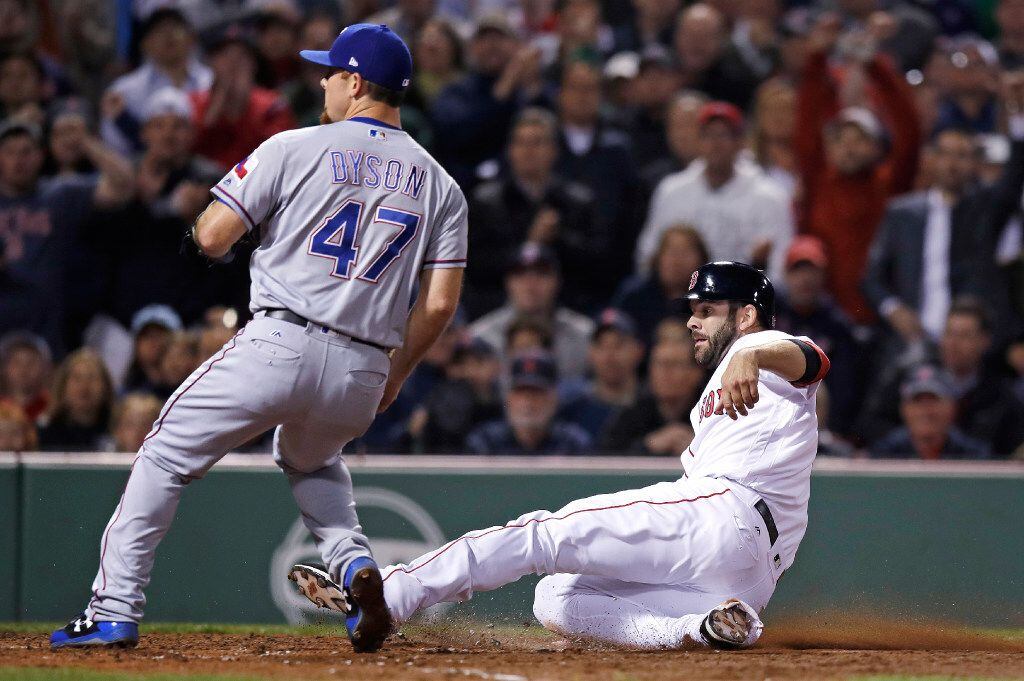 Boston Red Sox's Mitch Moreland scores on a wild pitch by Texas Rangers relief pitcher Sam...