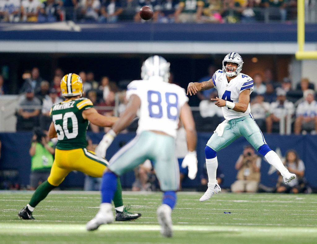 Dallas Cowboys quarterback Dak Prescott (4) attempts a pass to Dallas Cowboys wide receiver...