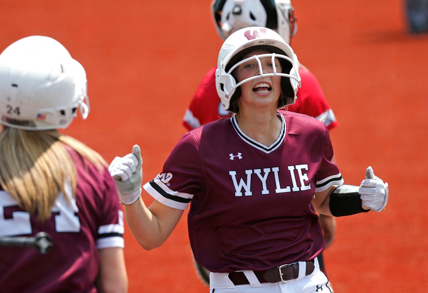 Wylie High School catcher Sydney Murphy (13) crosses the plate for the second of two...