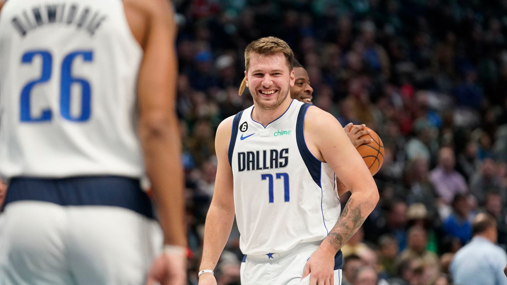 Dallas Mavericks guard Luka Doncic (77) has a laugh on the floor during the first half of an...