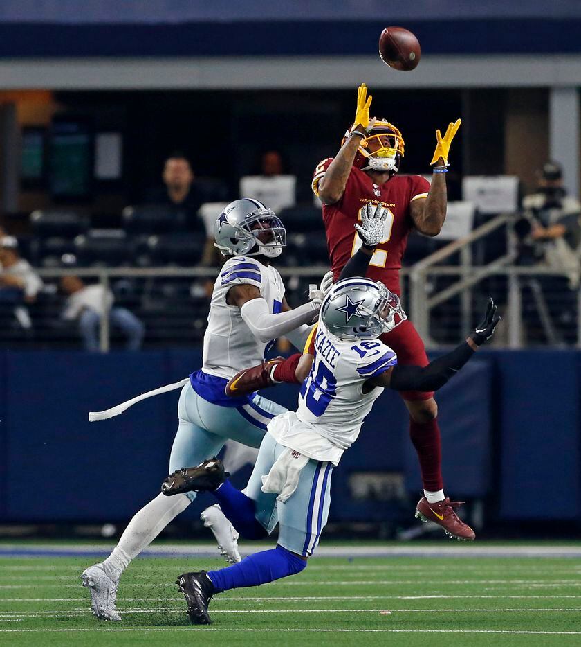 Washington Football Team wide receiver Dyami Brown (2) makes a catch over two Dallas defenders, including Dallas Cowboys free safety Damontae Kazee (18) during the first half of a NFL football game at AT&T Stadium in Arlington, TX on Sunday, December 26, 2021.