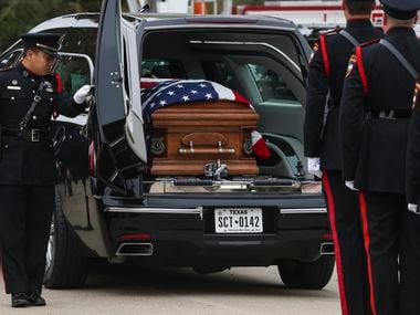 The casket of Grand Prairie police officer Brandon P. Tsai in the back of a hearse, Monday,...
