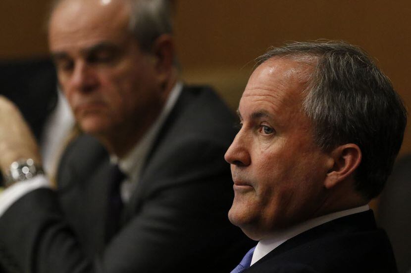  Texas Attorney General Ken Paxton, right, is shown at a hearing in December at the Collin...