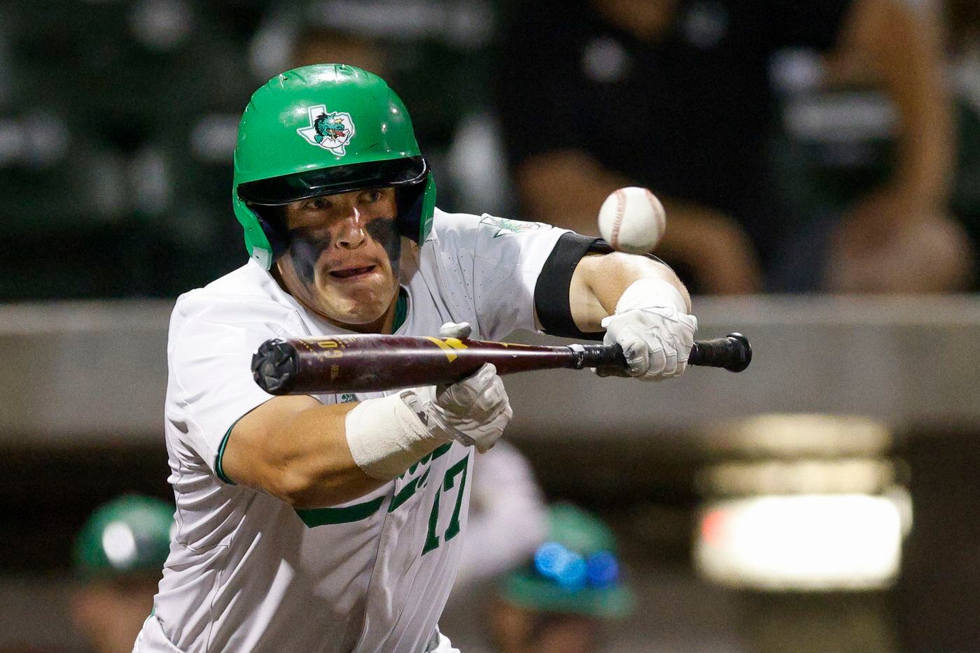 Southlake Carroll third baseman Tyson Drake (17) bunts for a single during the fifth inning...