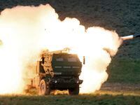 FILE - A launch truck fires the High Mobility Artillery Rocket System (HIMARS) produced by...