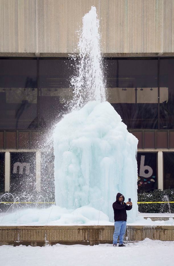 Carlos de Jesus takes a selfie in front of the frozen fountain at the Richardson Civic...