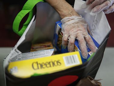 Volunteers packed free groceries for distribution to the elderly at Hope Community Services on Friday in New Rochelle, N.Y.