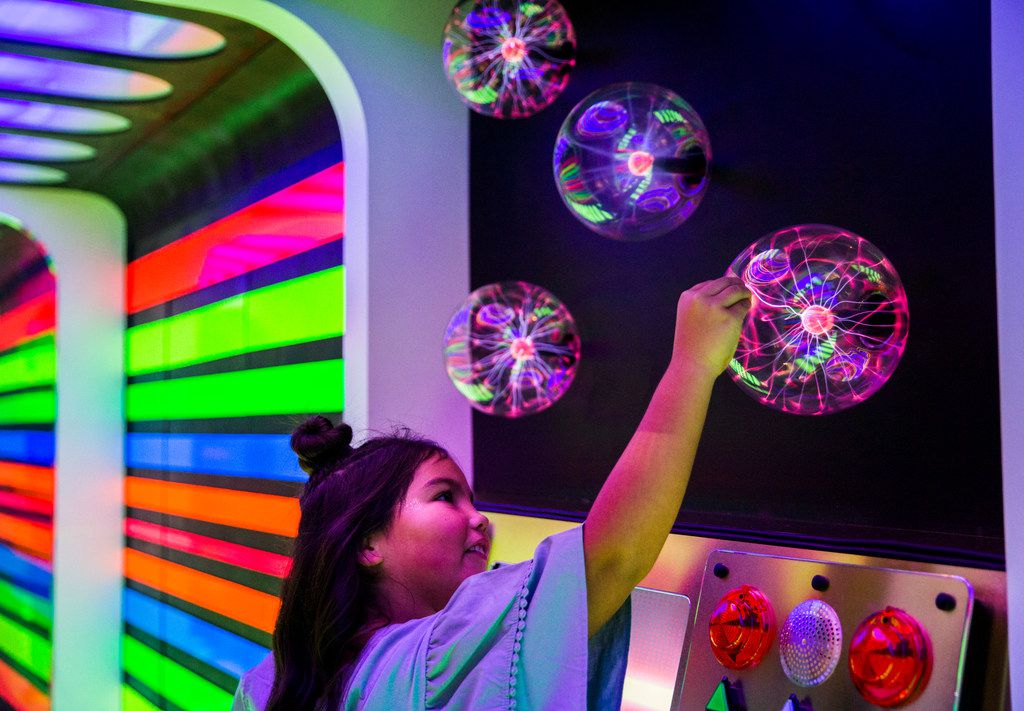 Ellie Colvin, 8, tests the control panel inside Rainbow Rocketship, created by artists Built...