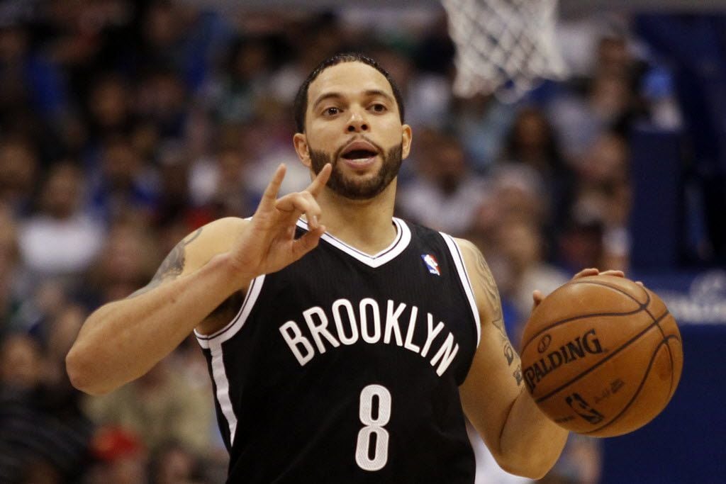 Brooklyn Nets' player Deron Williams communicates with his teammates during a game between...
