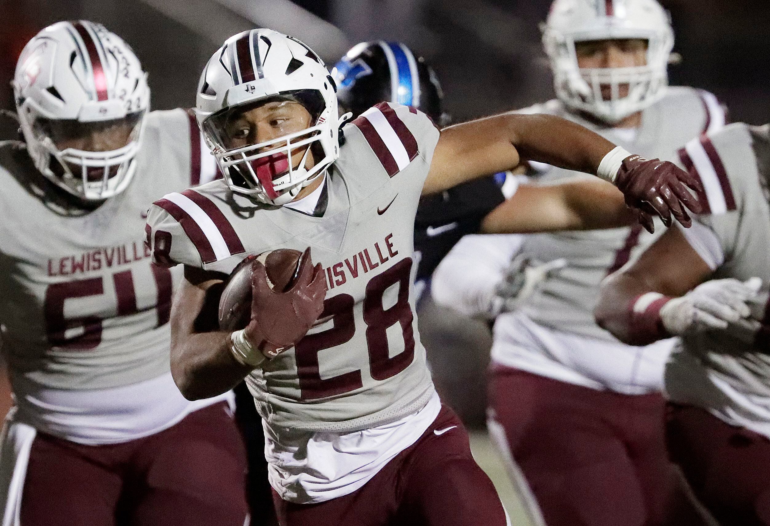 Lewisville High School running back Tenel Hill (28) carries the football during the second...
