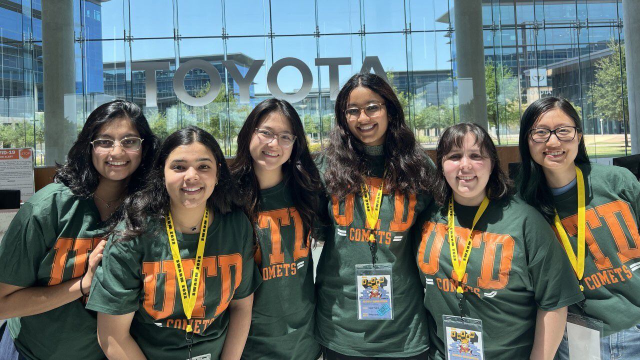 Six female UTD students posing at the SWARM Connected Mobility Hackathon in July.