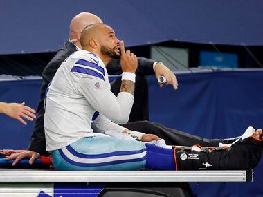 With tears in his eyes, Dallas Cowboys quarterback Dak Prescott (4) points skyward as he is carted off the field after sustaining an ankle injury in the third quarter at AT&T Stadium Stadium in Arlington, Texas, Sunday, October 11, 2020. The Cowboys are facing the New York Giants.