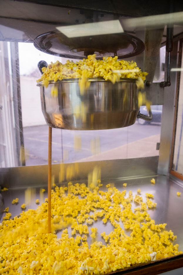 Popcorn falls out of the popcorn maker at Lone Star Donuts on Tuesday, Feb. 7, 2023, in...