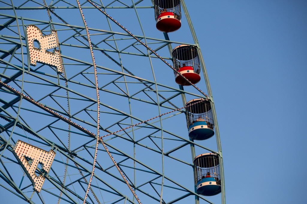 Festivalgoers ride on the Texas Star Ferris wheel during the free festival celebrating the...