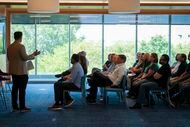 Workers participate in a hybrid all-hands meeting at the Fannie Mae's Plano offices on Aug. 11.