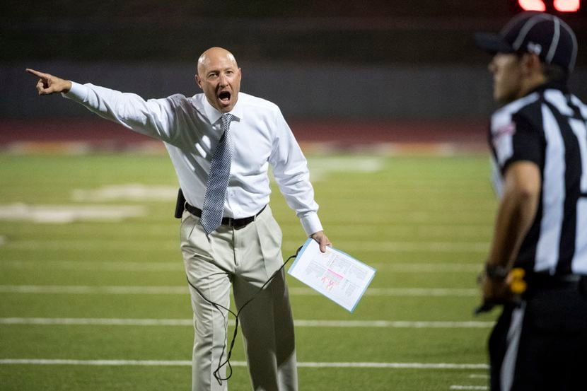 Grapevine Faith football coach Kris Hogan shares his opinion with a referee during a game...