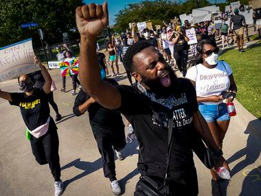 Brandon Moore leads marchers during a protest on Thursday, June 4, 2020, in Addison....