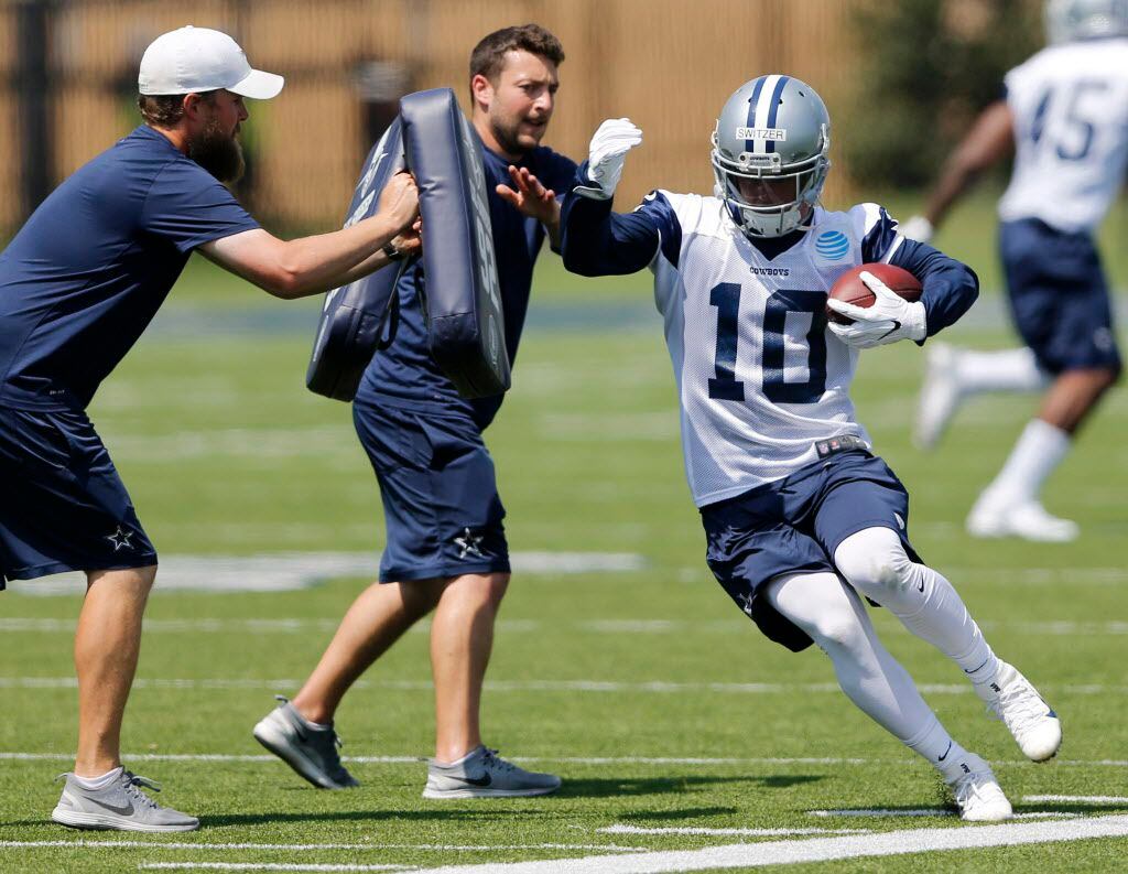 Dallas Cowboys Ryan Switzer (10) attempts to stay in bounds as he is pushed in a drill...