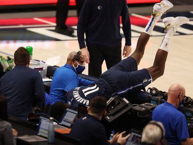 Dallas Mavericks forward Tim Hardaway Jr. (11) falls over after diving for a loose ball in a...