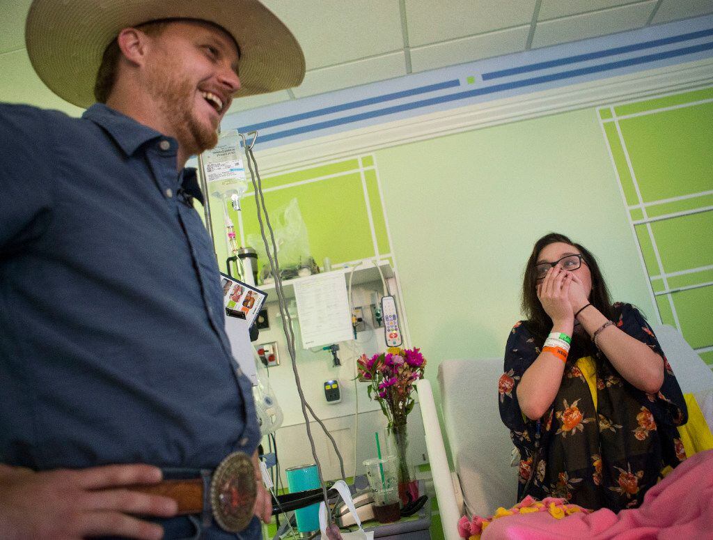 Singer-songwriter Cody Johnson, left, surprises Danielle Grey, 19, with a visit at Cook...
