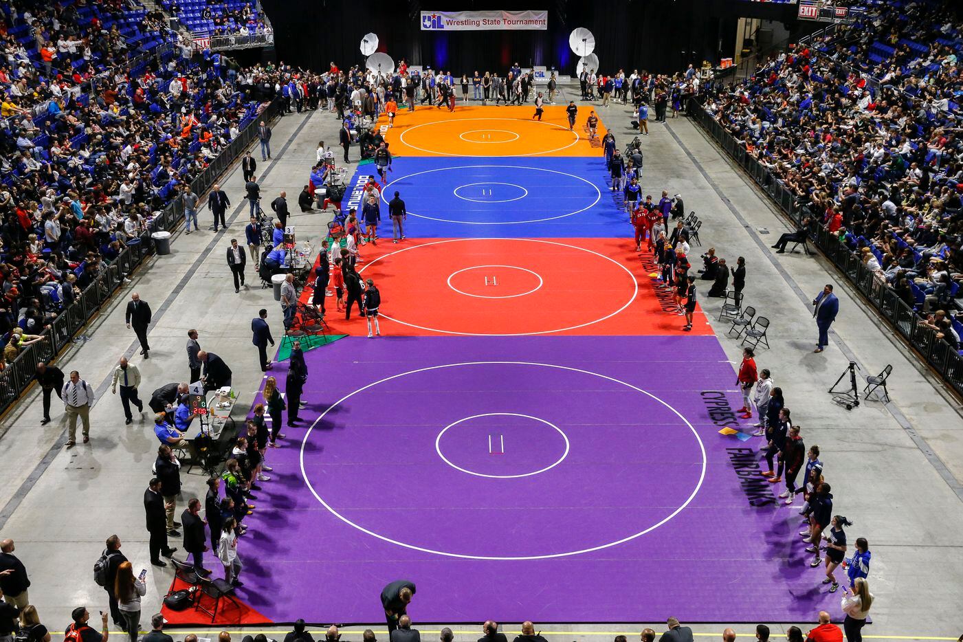 Wrestlers enter the arena floor during the parade of champions at the UIL State Wrestling...