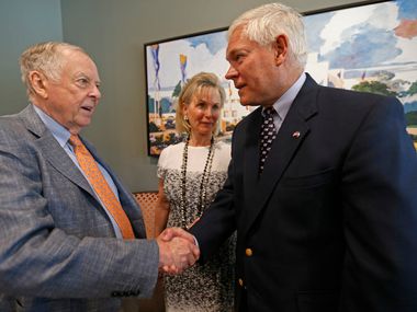 T. Boone Pickens (left) shakes hands with Rep. Pete Sessions (right) as Toni Brinker Pickens...