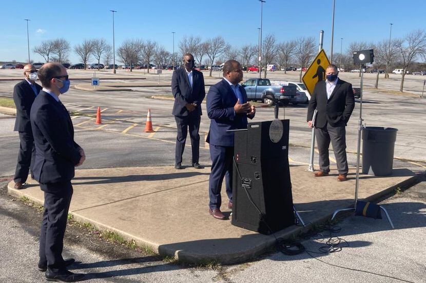 Dallas Mayor Eric Johnson, center, speaks to members of the media Thursday March 4, 2021 at...