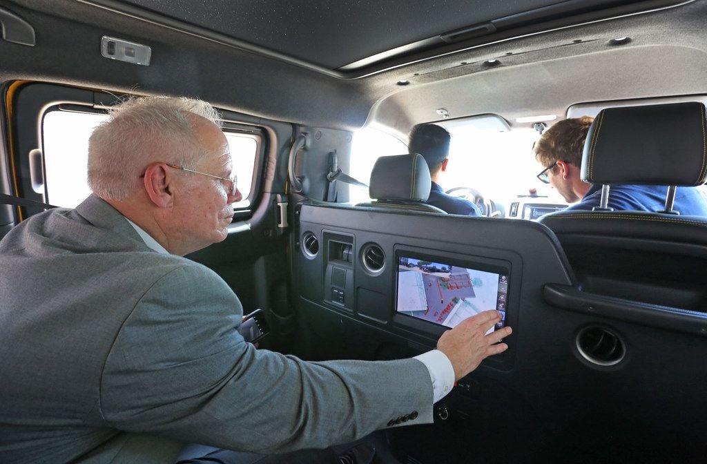 Frisco Deputy City Manager Henry J. Hill examines a video display in the  back seat of a...