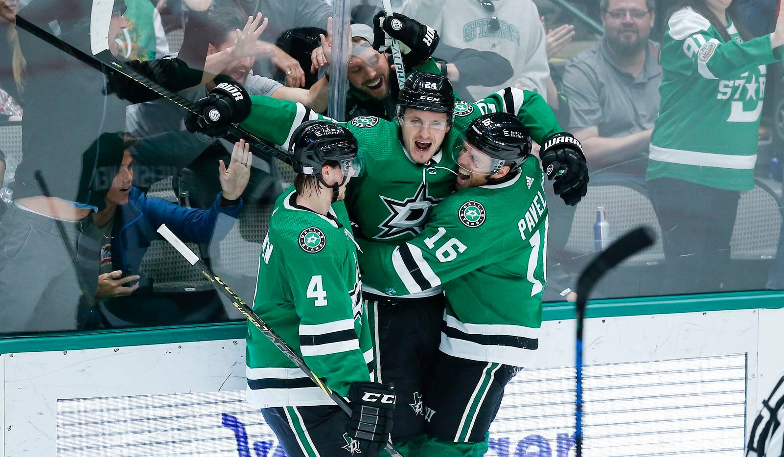 Dallas Stars forward Roope Hintz, center, is congratulated by defenseman Miro Heiskanen (4) and forward Joe Pavelski (16) after scoring a goal during the second period of an NHL hockey game against the Detroit Red Wings, Tuesday, November 16, 2021.